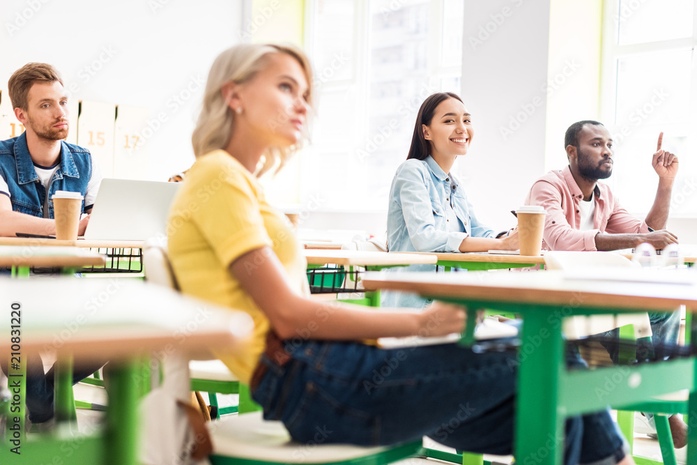 Fototapeta premium focused young students sitting in classroom during lesson