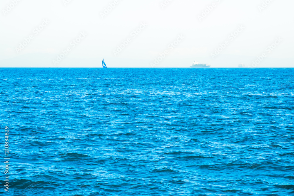 Lonely sailing boat in open sea. Beautiful romantic landscape, seascape. Luxury sports and recreation background. Horizontal image with copy space. 