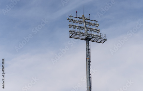 The Stadium spot-light tower over blue sky background.