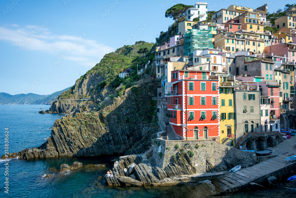 Horizontal View of the Town of Riomaggiore Builded on the Cliff on Blue Sky Background.