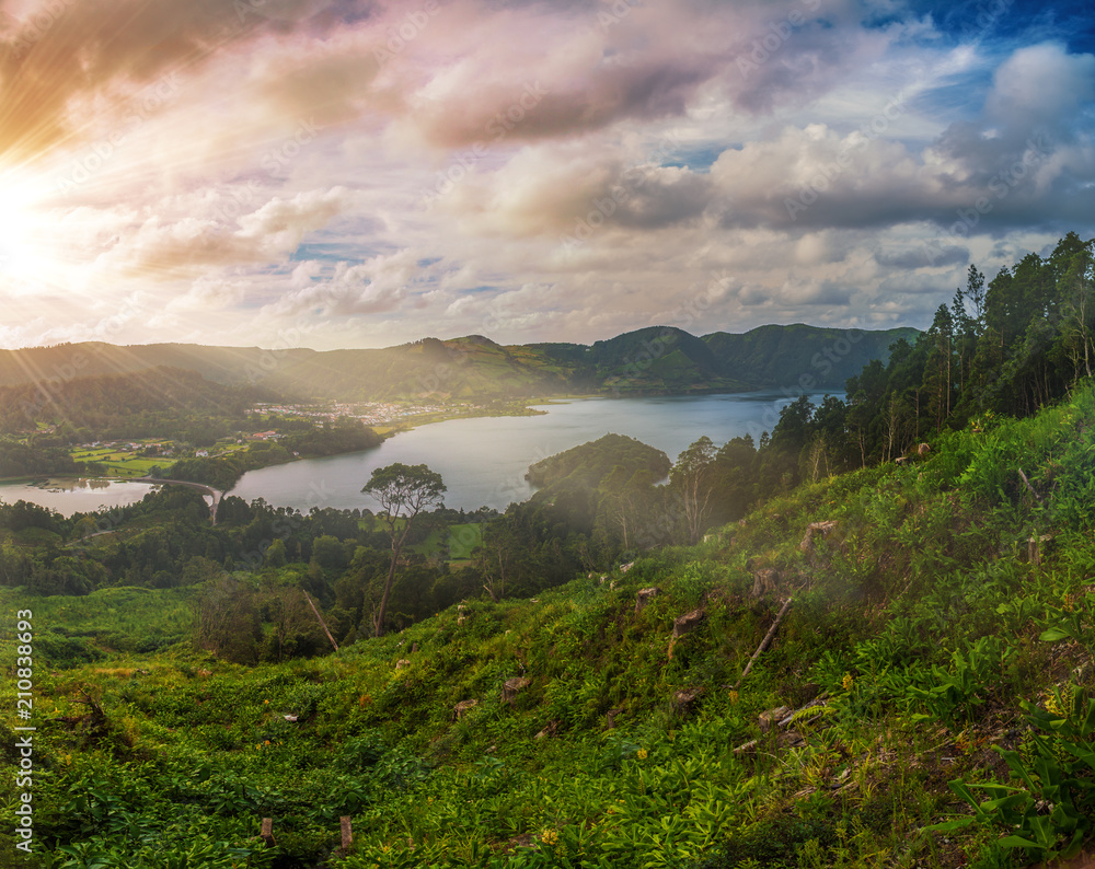 Obraz premium Beautiful sunset volcanic lake among mountains with green lush and trees in Ciete Cidades valley