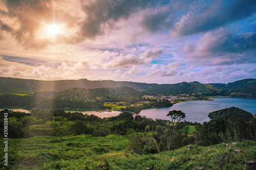 Beautiful sunset volcanic lake among mountains with green lush and trees in Ciete Cidades valley