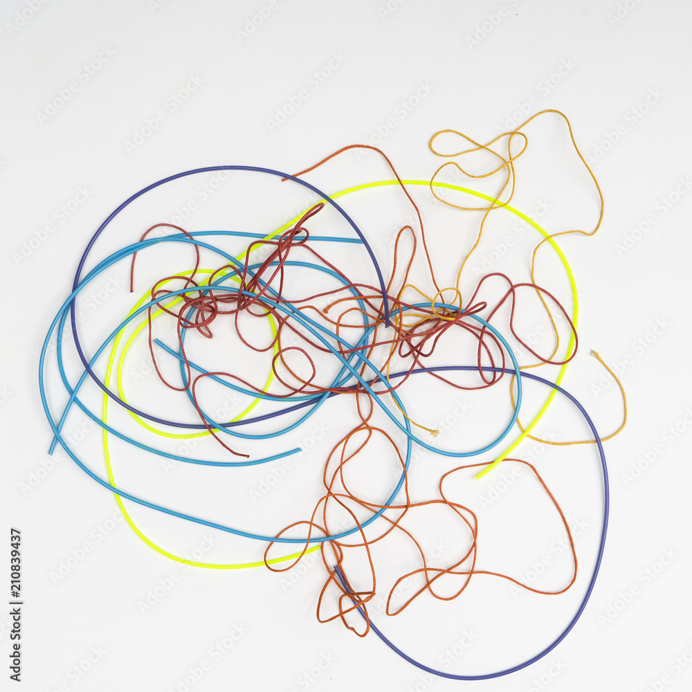 colored threads on a white surface colored threads on a white surface