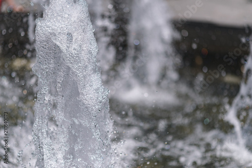 City fountain. Selective focus on water drops.