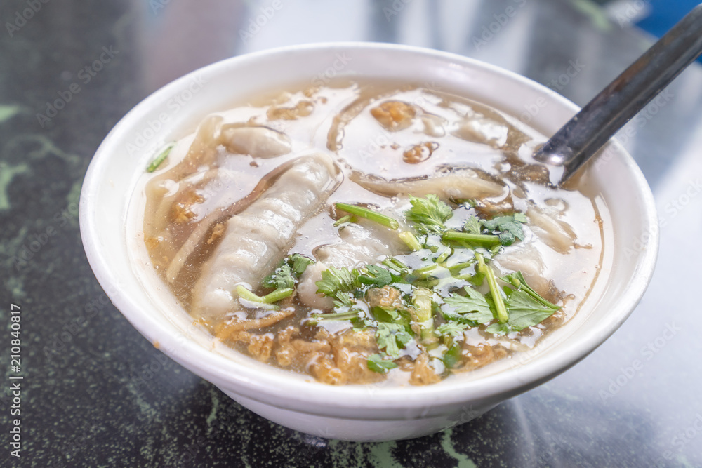 Taiwan's distinctive famous snacks: fish meatball potage soup in a white bowl on stone table, Taiwan Delicacies, Taiwan Street Food