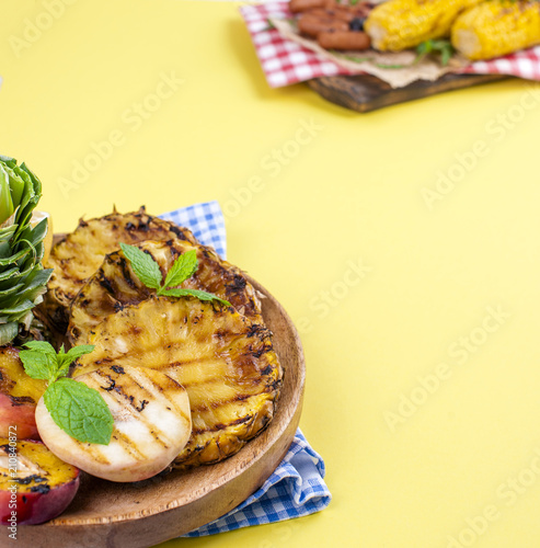 Pineapple and peach barbecued grilled picnic. Free space for text. Summer Lunch. Copy space. flat aly.
