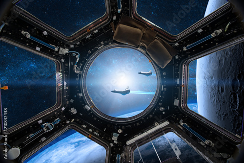 Fototapeta Naklejka Na Ścianę i Meble -  View from a porthole of space station on the Earth background. Elements of this image furnished by NASA.