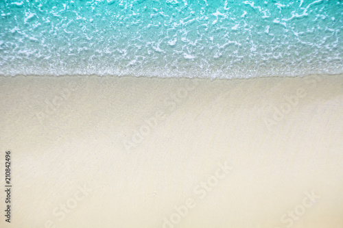 Soft wave of blue ocean on sandy beach. Empty blue sea. View of nice tropical beach Horizon with Cream color sand . Holiday and vacation concept. © Nitiphonphat