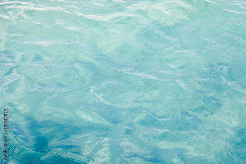 Blue sea ocean water background .Tropical Pattern blue ripple curl water in swimming pool . © Nitiphonphat