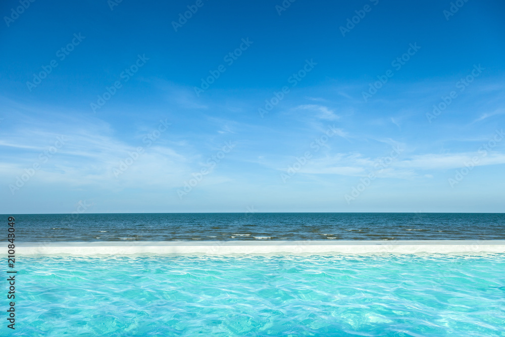 View of nice Tropical beach blue ripple curl water in swimming pool with sky and Horizon at spa resort in Hua Hin Thailand. Holiday and vacation relaxing concept.Blue sea ocean water