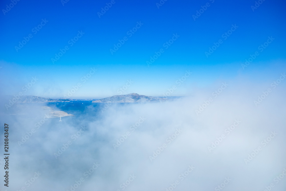 Marin headland and San Francisco bay on foggy day with clear blue sky