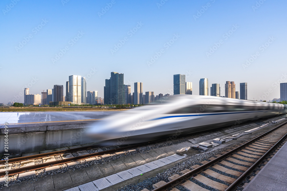 Fototapeta premium high speed train with city skyline