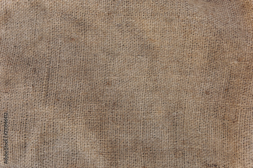 Old vintage linen cloth textile. Burlap rustic tumbled texture background.