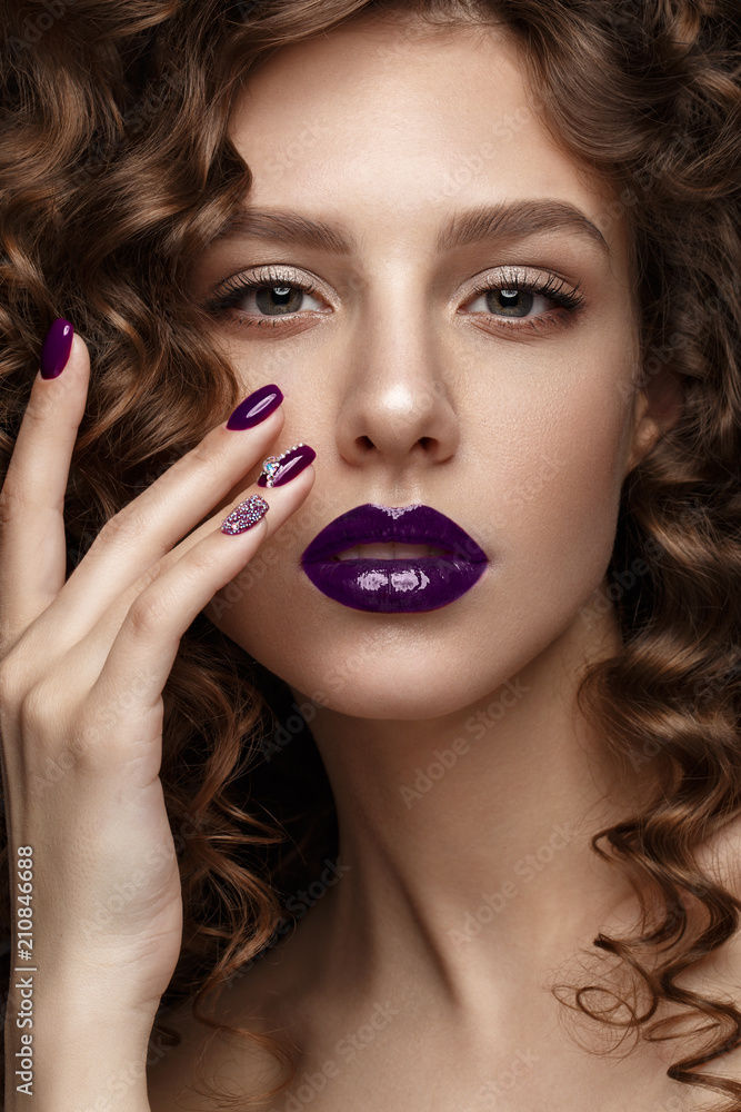 Beautiful girl with evening make-up, purple lips, curls and design manicure nails. beauty face. Photos shot in studio. Beautiful girl with evening make-up, purple lips, curls and design manicure nails. beauty face. Photos shot in studio.