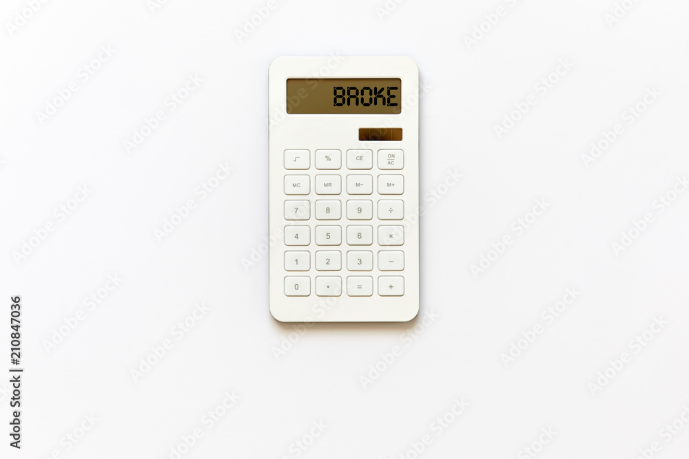 White powered solar calculator isolated on white background viewed from above in studio with broke message showed at the screen. White powered solar calculator isolated on white background viewed from above in studio with broke message showed at the screen.