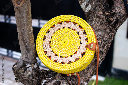 Fashionable stylish rattan bag outside. Tropical island of Bali, Indonesia. Rattan handbag. photo