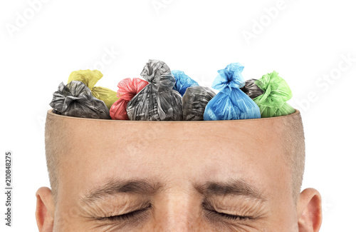 Сoncept of knowledge. Garbage bags is in cut of the head  on a white background. Unnecessary information.