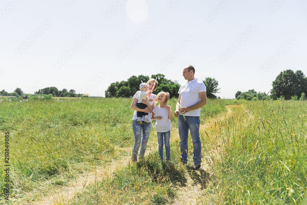 Family walks in the field. Family with soap bubbles. A family with two children. A full-fledged family. Family walks in the field. Family with soap bubbles. A family with two children. A full-fledged family.