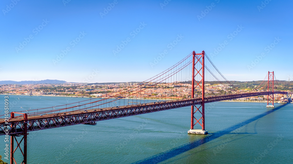 Ponte 25 de Abril. Most famous bridge in Portugal. Lisbon. Red bridge. Sunny day. Ponte 25 de Abril. Most famous bridge in Portugal. Lisbon. Red bridge. Sunny day.