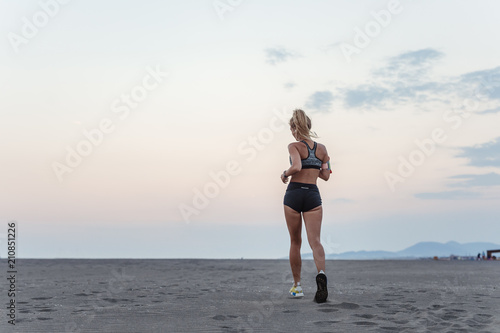Woman Runnning on Sandy Beach