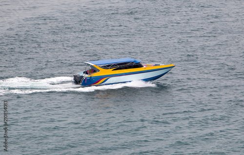 A motorboat rides quickly on the sea.