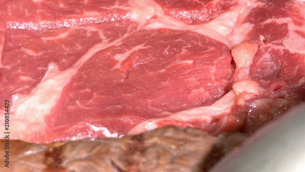 Full screen macro of the delicious marbled beef steak on the grill Full screen macro of the delicious marbled beef steak on the grill