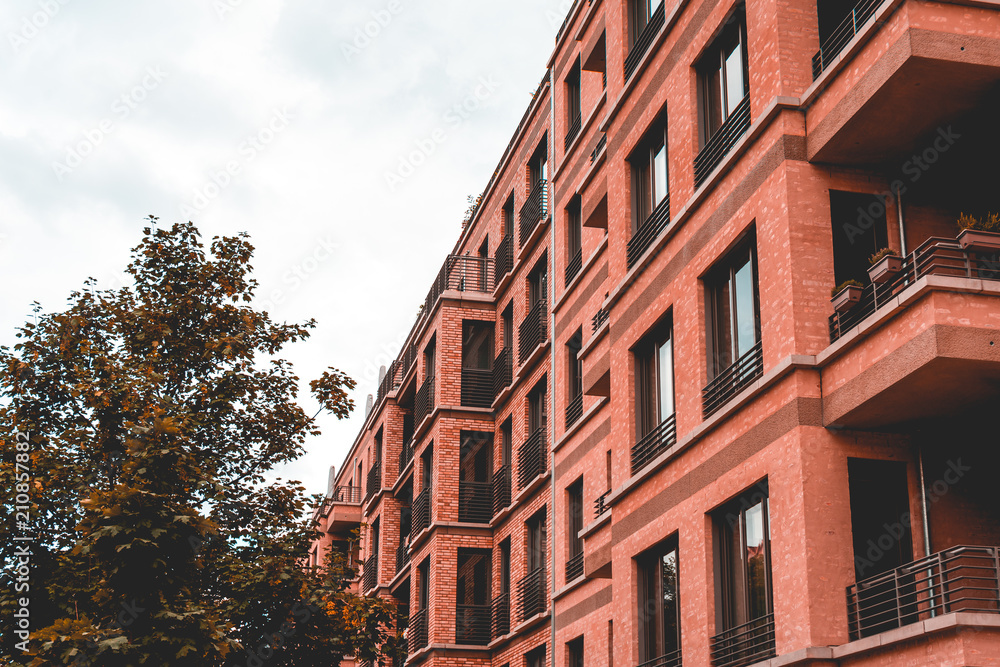 Fototapeta premium red colored apartment complex on a cloudy day