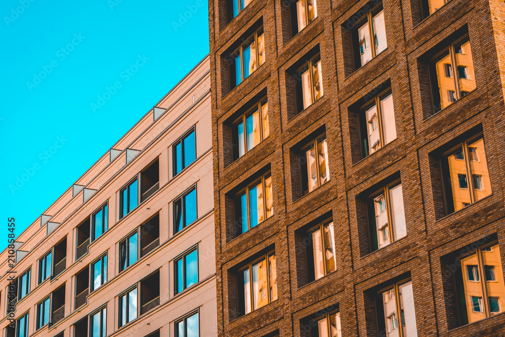 white and brown office buildings with some reflections in the blue windows