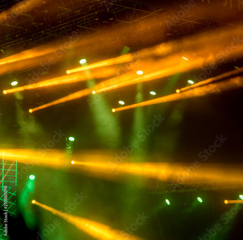 abstract magic image with rays of colored light from the spotlights in the dark