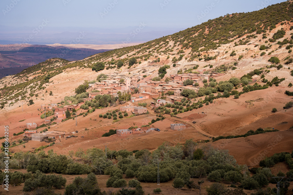 Small Moroccan rural village in Atlas mountains with lots of trees
