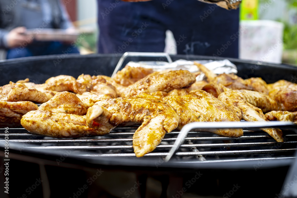 Chicken wings are cooked on the grill, close-up.
