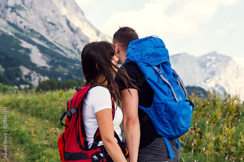 Beautiful hiking couple enjoying in nature.Couple sharing love while walking in nature