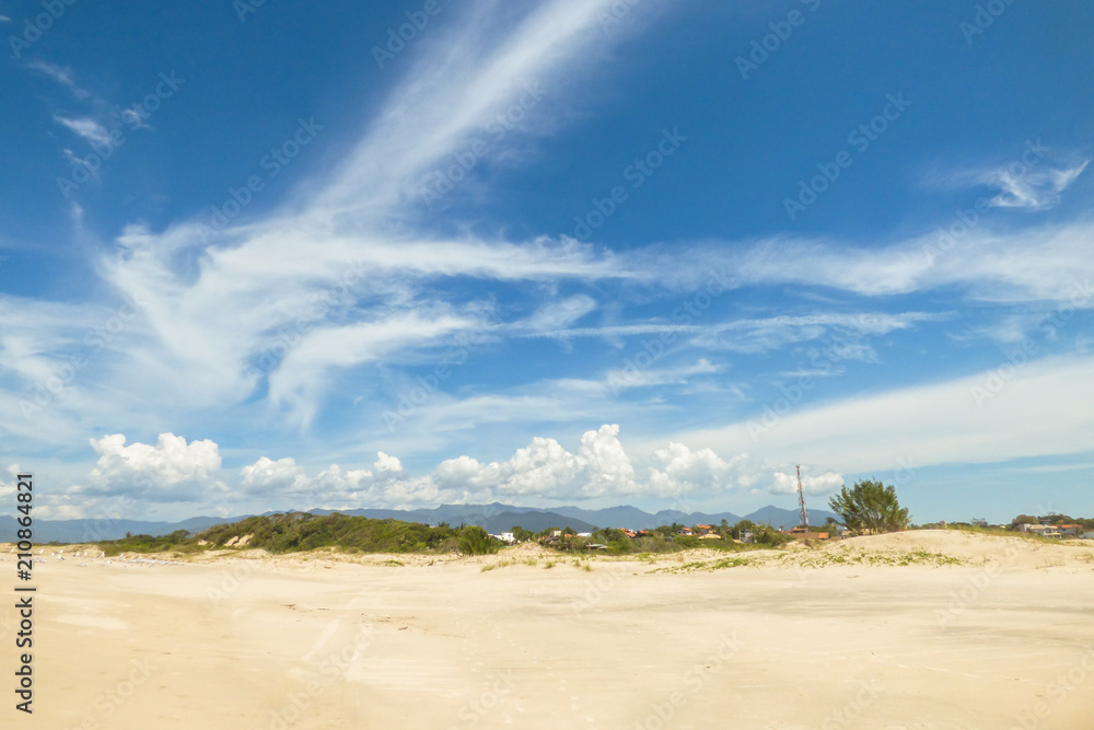 Sand and blue sky at Guarda do Embau beach in Santa Catarina, Brazil