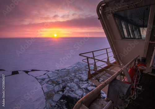 View from the wheelhouse of the Russian icebreaker on the Arctic sunset. Travel across the Kara sea.