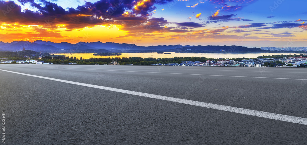 Fototapeta premium Asphalt road square and river hill under the blue sky