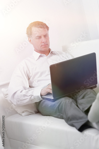 businessman working on laptop while sitting in a hotel room © ASDF