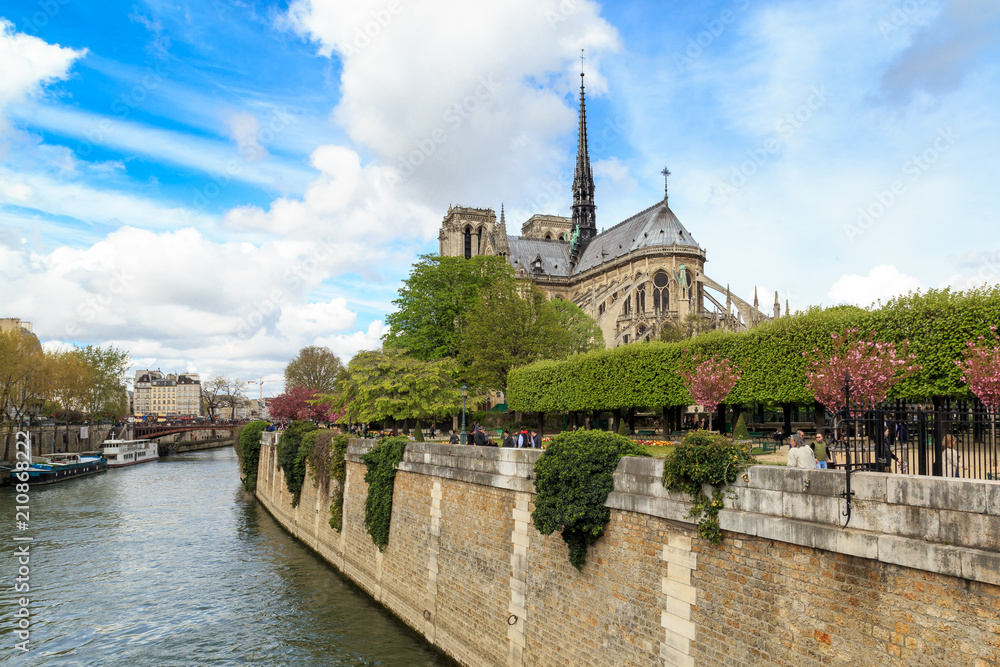 Notre Dame with boat on Seine in Paris, France