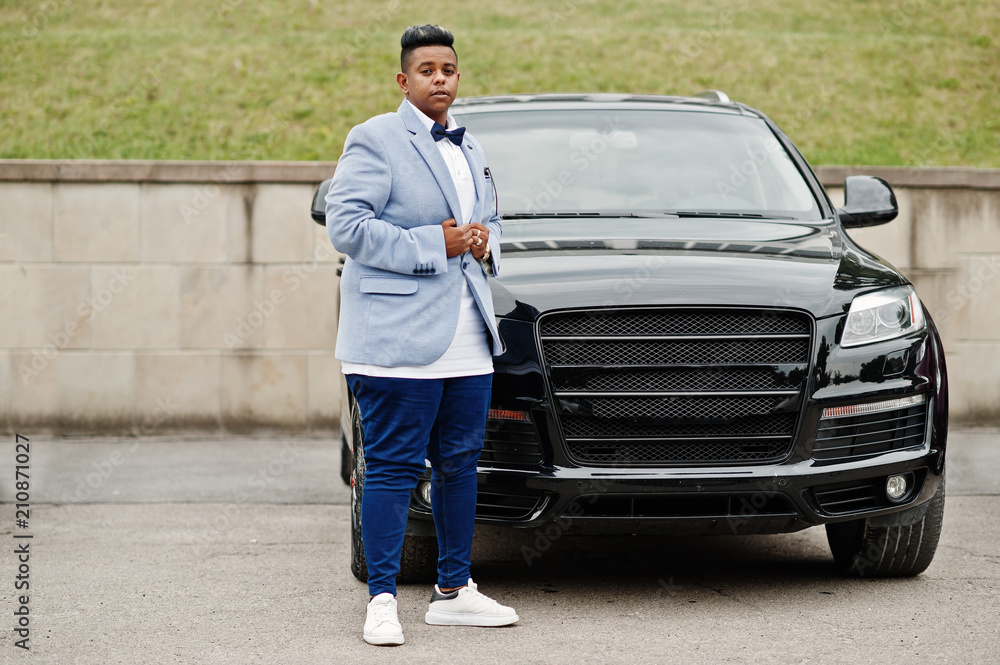 Stylish arabian man in jacket, bow tie against black suv car. Arab rich businessman. Stylish arabian man in jacket, bow tie against black suv car. Arab rich businessman.