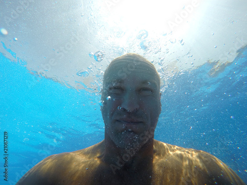 The face of a man under water.