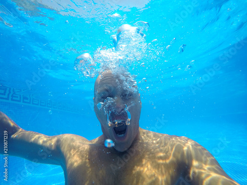 The face of a man under water.