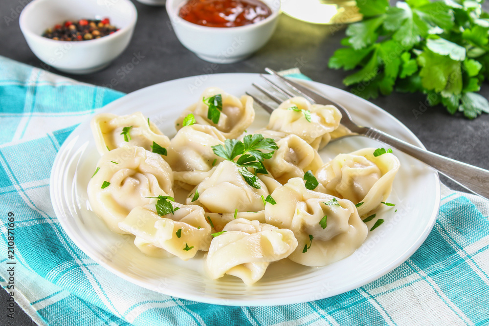 Homemade ready dumplings on a gray concrete table. Homemade ready dumplings on a gray concrete table.