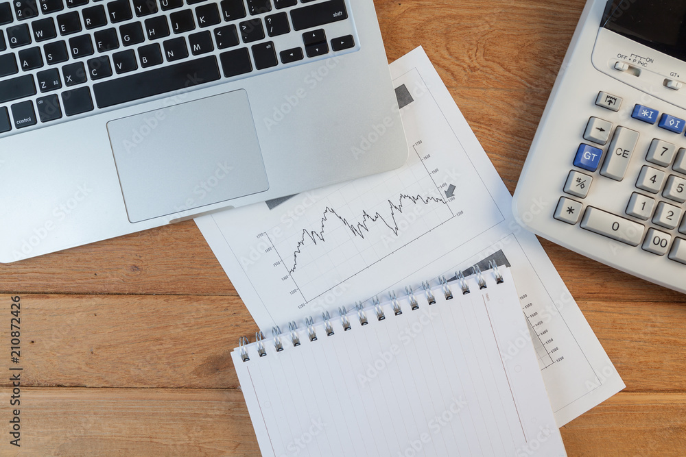 Open laptop with digital tablet and white smartphone, business and investment concept Open laptop with digital tablet and white smartphone, business and investment concept