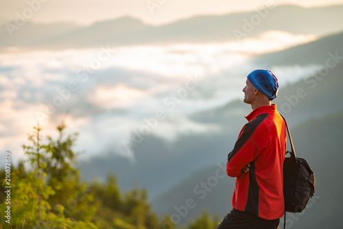 Happy adventurer on the mountain top during sunset © sanechka