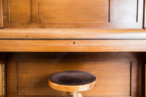 Old wooden vintage piano keys on wooden musical instrument in front view photo