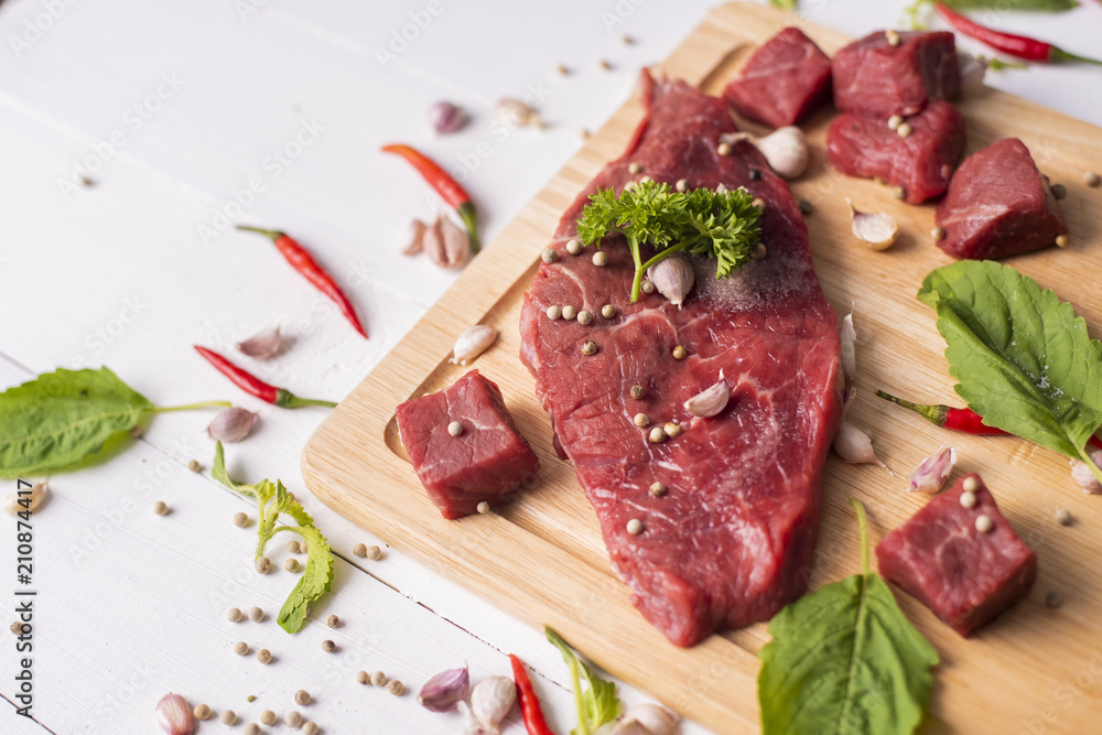 Raw beef on white wood background