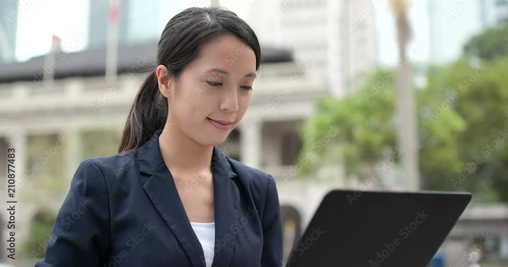 Asian Businesswoman work on notebook computer in city of Hong Kong Asian Businesswoman work on notebook computer in city of Hong Kong