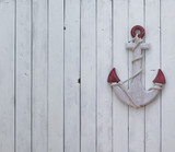 decorative wooden anchor on a white wooden wall