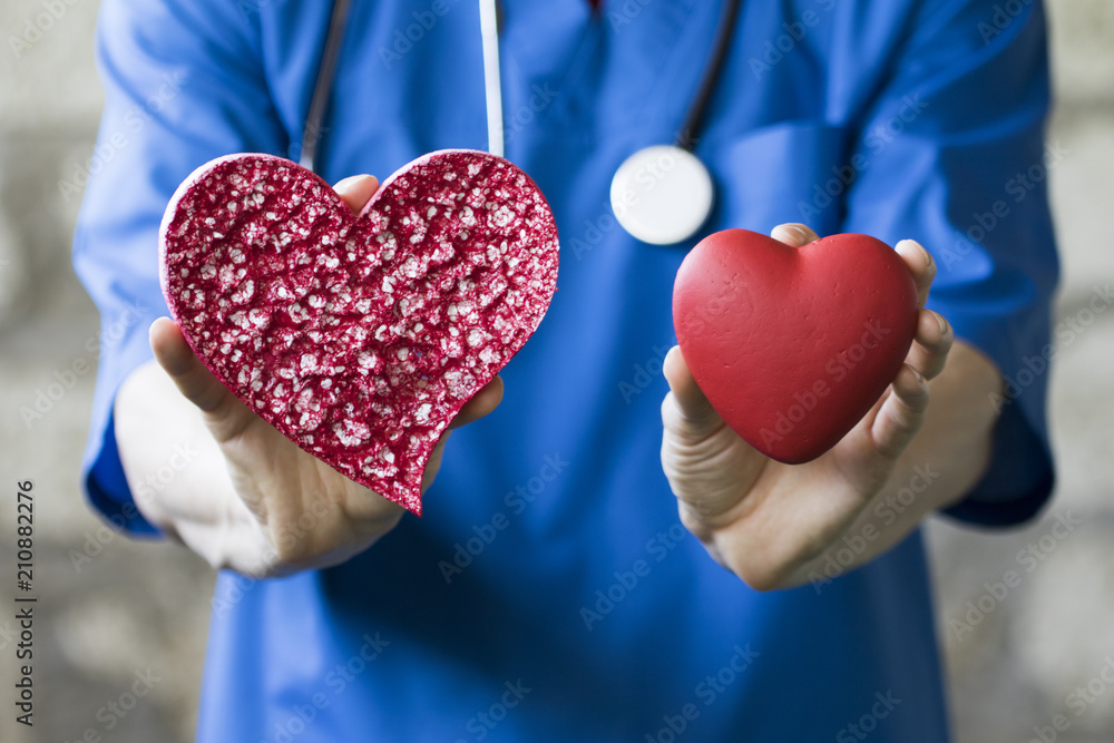 Heart in hands doctors on background medicine service