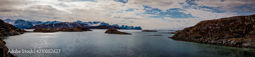 mountain peaks covered with snow  islands and ocean in northern Norway