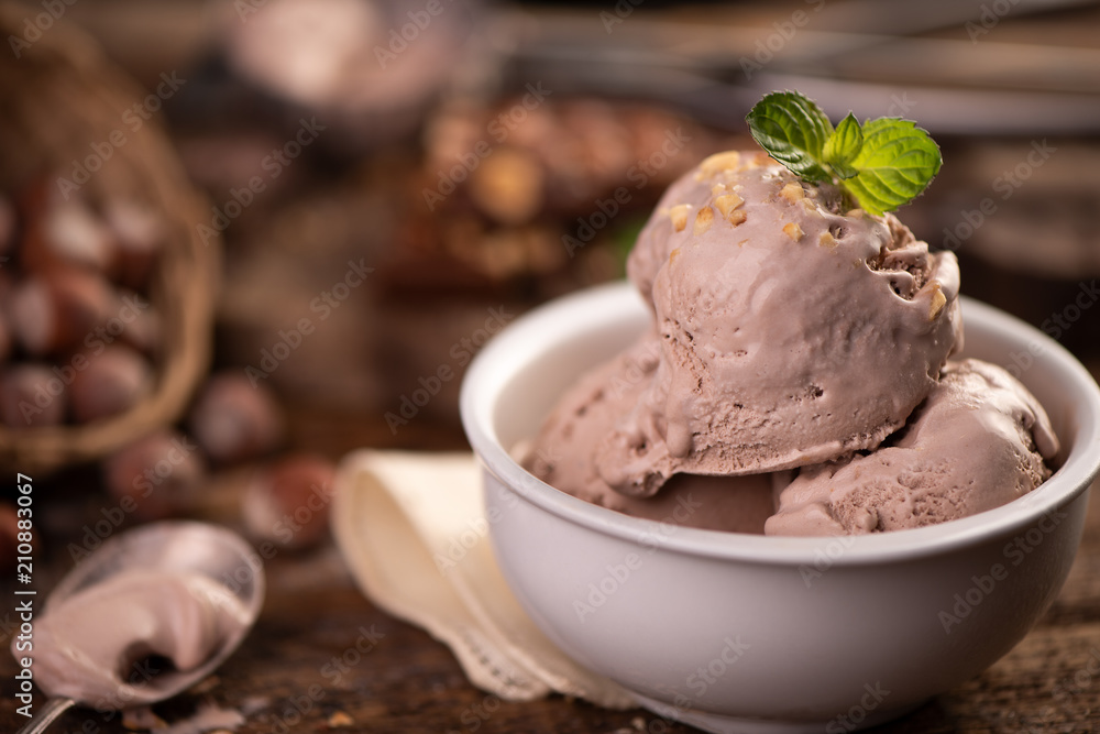 Fresh hazelnut ice cream on wooden table. Fresh hazelnut ice cream on wooden table.
